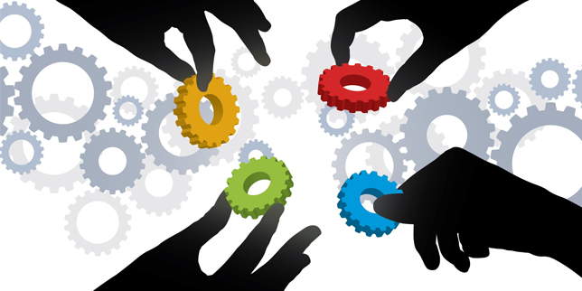 Illustration of four hand silhouettes, each holding a different-colored gear that they are bringing together in the center of a background of other gears in various shades of light gray. 