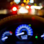 Stock image of an out-of-focus car dashboard at night