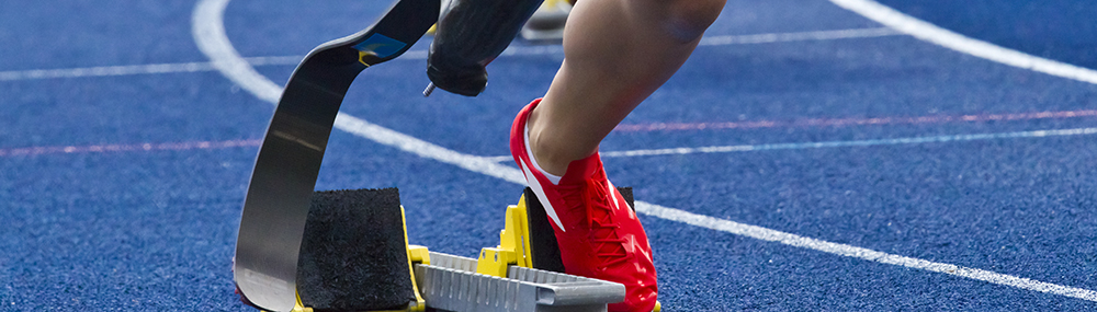 A runner with a prosthetic leg on a track.