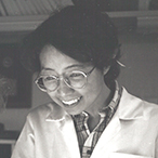 Black and white, undated photograph of a young Dr. Ozato and a colleague, both wearing lab coats.