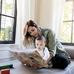 Woman and infant looking at picture book.