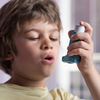 Child preparing to use an inhaler.