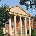 A brick building with six columns at the front entrance. “National Institutes of Health” is visible at the top.