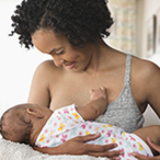 Woman breastfeeding infant.