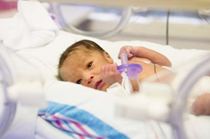 Preterm infant in hospital bed